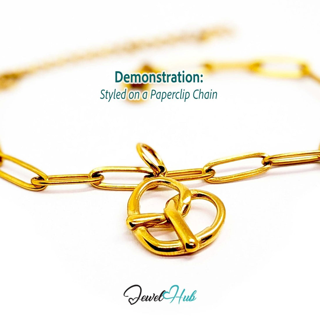 Large openwork pretzel charm in gold stainless steel - styled on a gold paperclip chain bracelet - JewelHub
