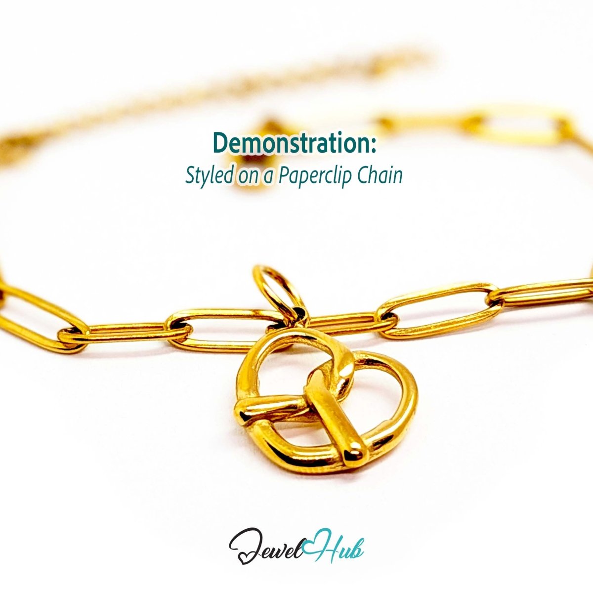 Large openwork pretzel charm in gold stainless steel - styled on a gold paperclip chain bracelet - JewelHub