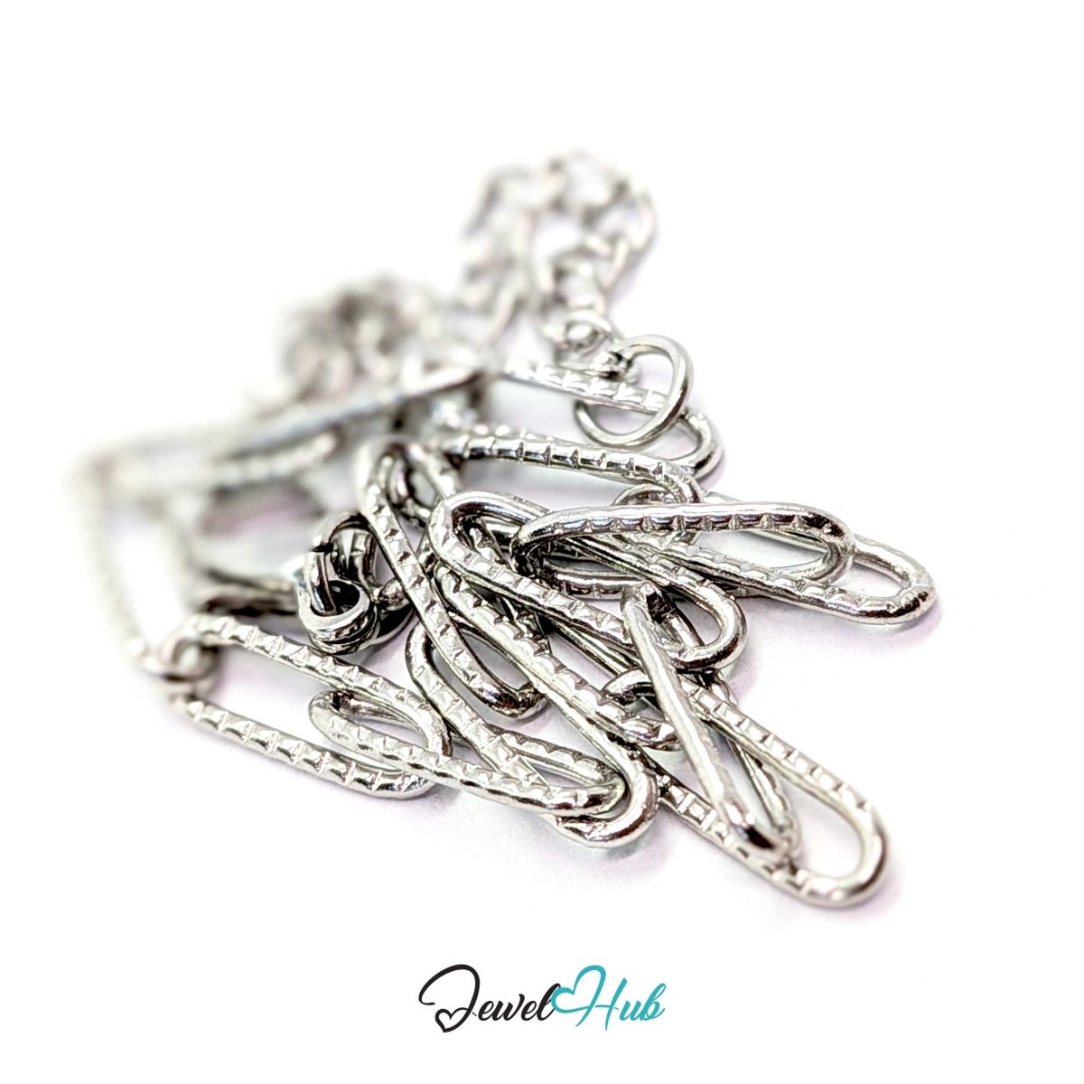 Patterned silver paperclip chain bracelet coiled to show its 3g weight and textured finish - JewelHub