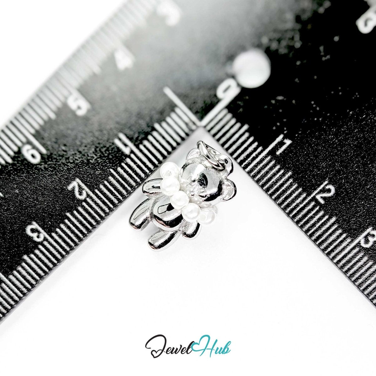 Silver Pearl Collar Bear charm measured against a ruler at 12mm wide by 20mm tall - JewelHub