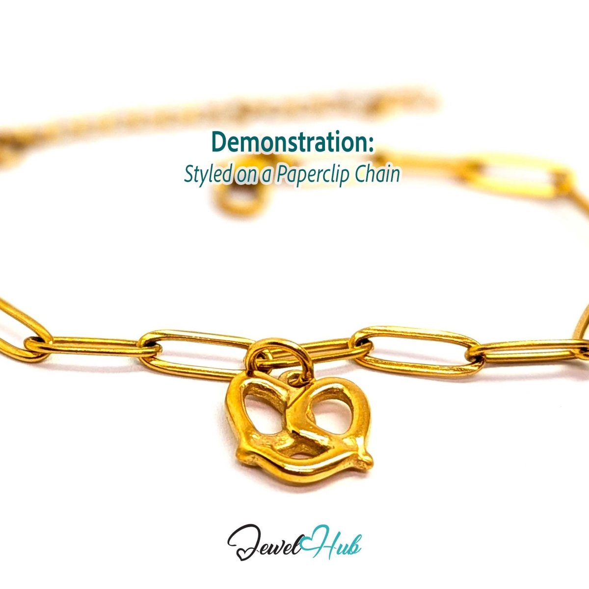 Openwork pretzel charm in gold stainless steel - styled on a gold paperclip chain bracelet - JewelHub