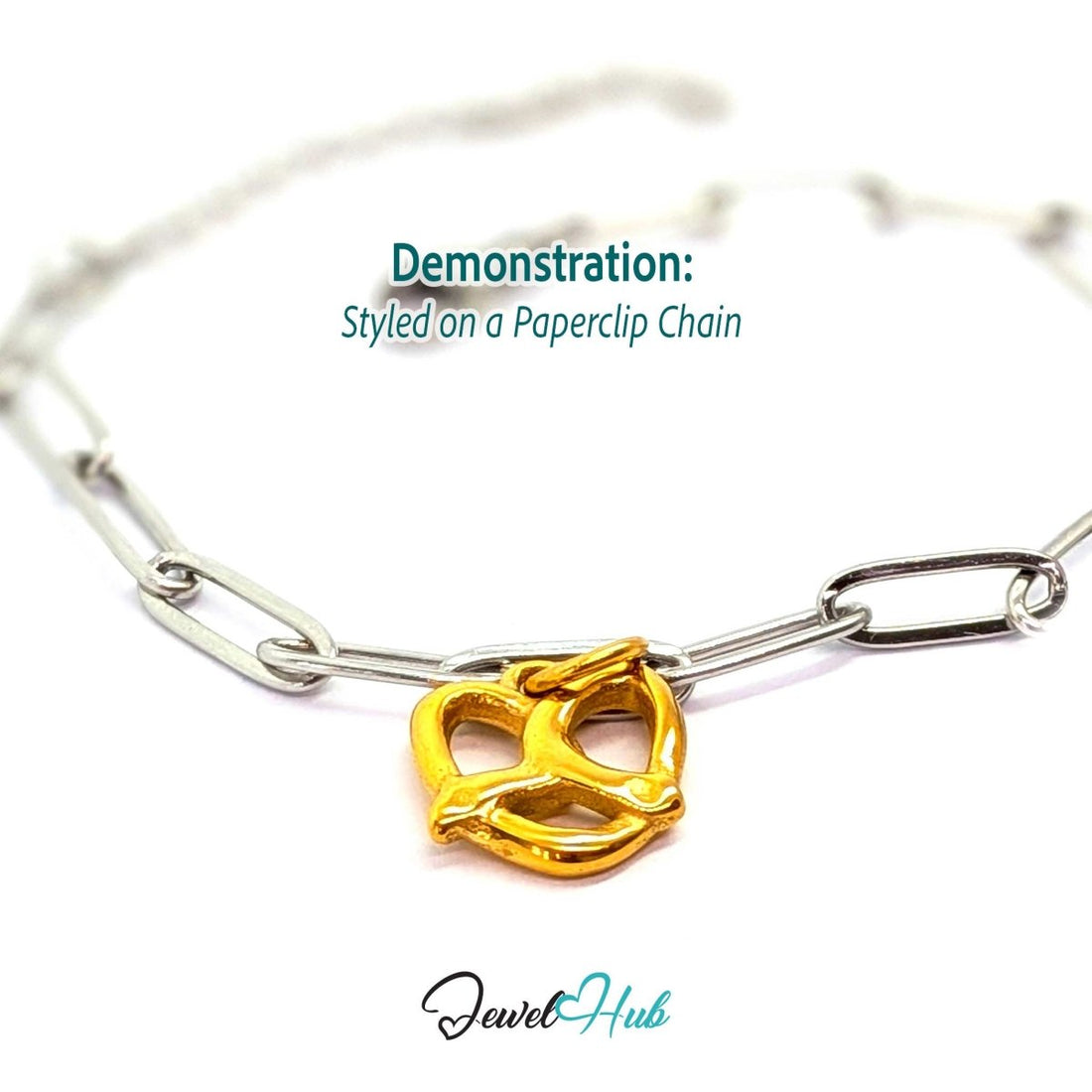 Openwork pretzel charm in gold stainless steel - styled on a silver paperclip chain bracelet - JewelHub