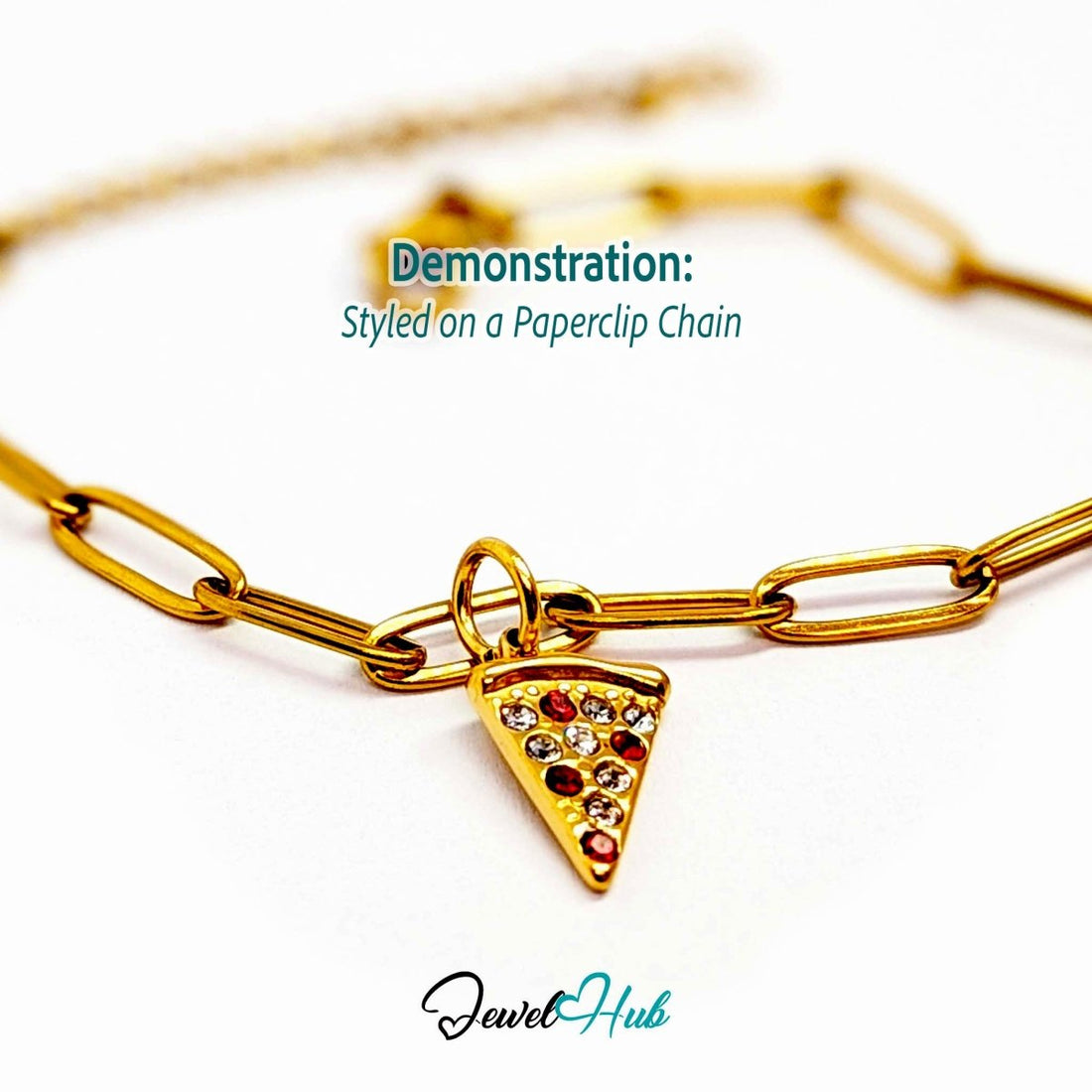 Pizza slice charm in gold stainless steel set with clear and red crystals - styled on a gold paperclip chain bracelet - JewelHub