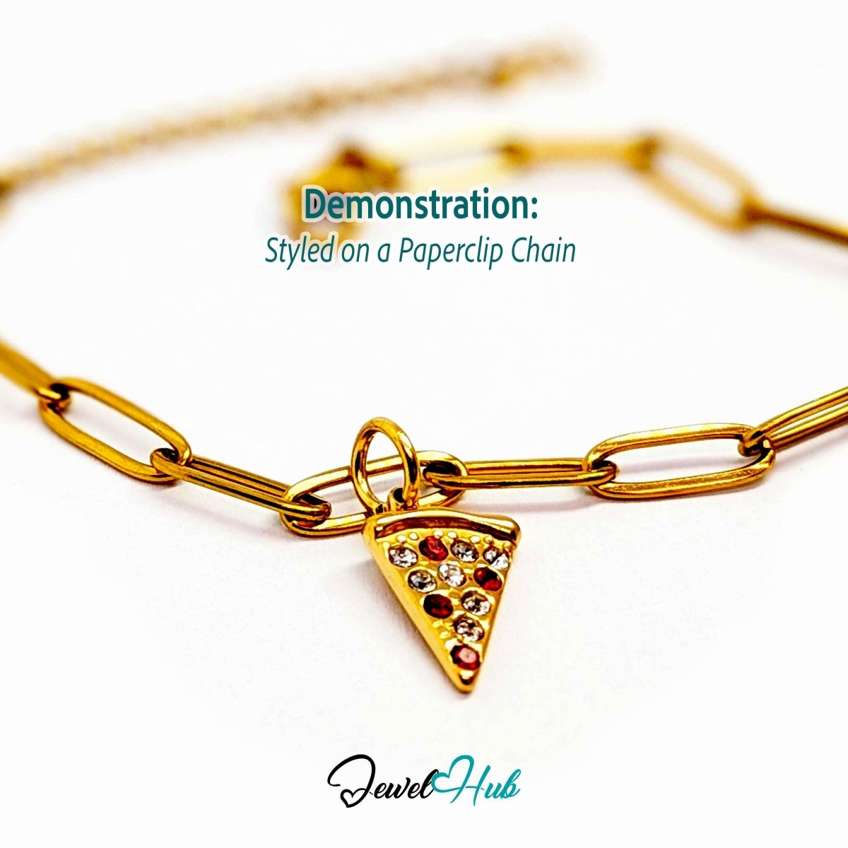Pizza slice charm in gold stainless steel set with clear and red crystals - styled on a gold paperclip chain bracelet - JewelHub