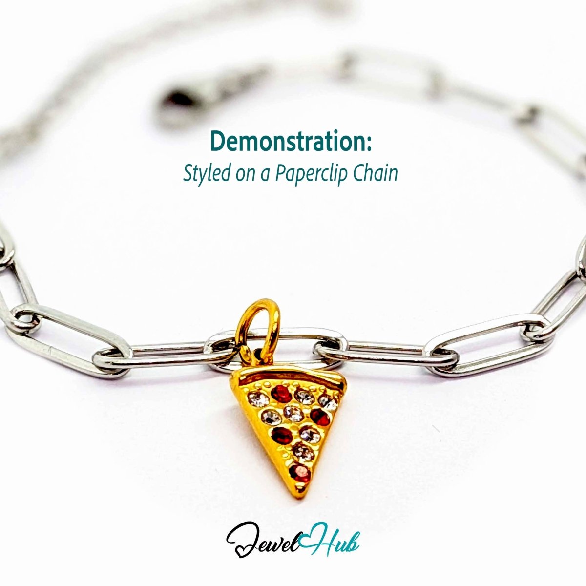 Pizza slice charm in gold stainless steel set with clear and red crystals - styled on a silver paperclip chain bracelet - JewelHub