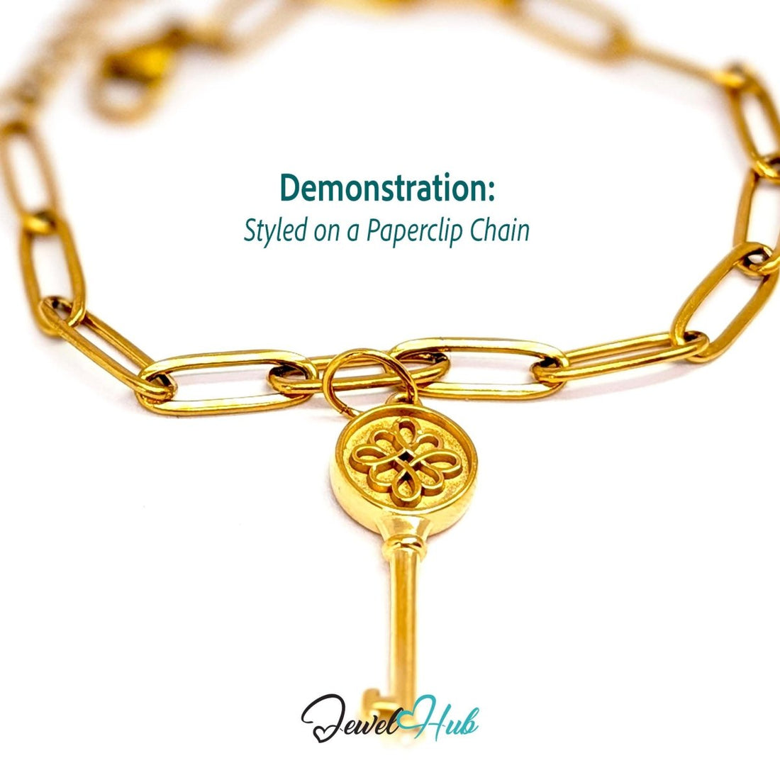 Round openwork key charm in gold stainless steel - styled on a gold paperclip chain bracelet - JewelHub