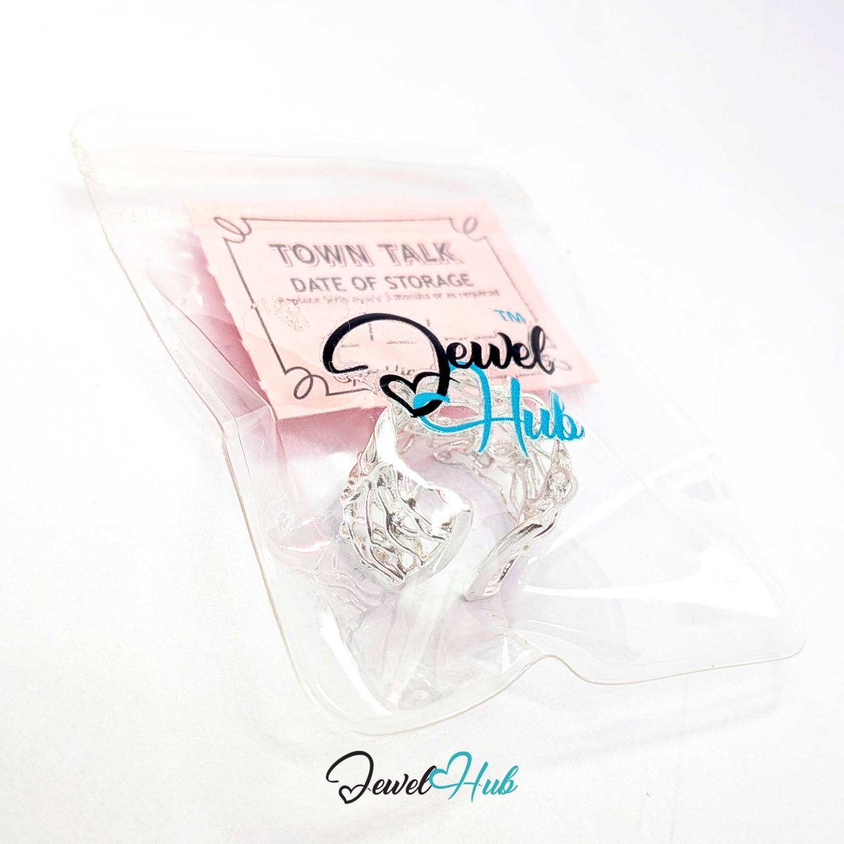 A pair of silver-toned hoop earrings inside a clear plastic bag with a pink card labeled 'TOWN TALK DATE OF STORAGE' and a visible JewelHub logo watermark.