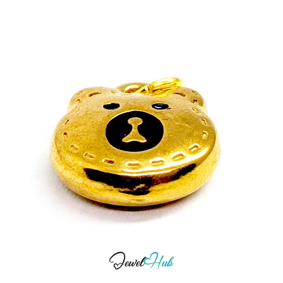 Close-up of the engraved stitch marks and black enamel eyes on the gold bear head charm - JewelHub